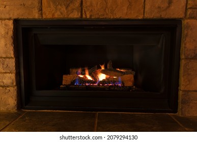 Burning Natural Gas Fireplace During The Evening At Home 