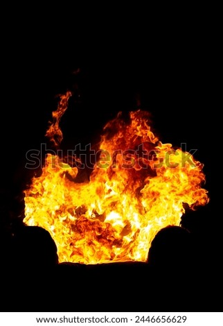burning office chair on a black isolated background, all in fire and smoke