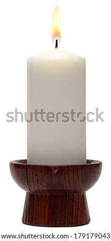 burning old candle vintage wooden candlestick. Isolated on a white background. 