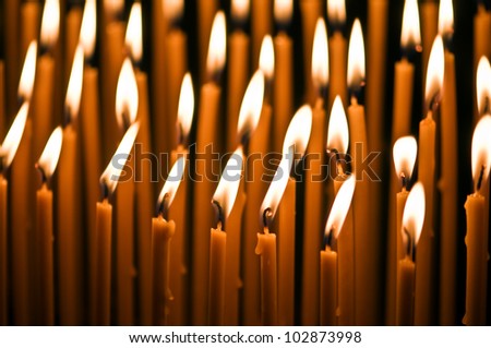 burning orange candles close up