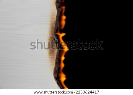 Burning paper on black background. Burnt paper edges.