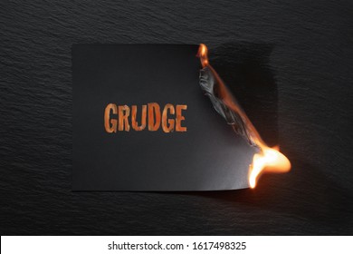 Burning Piece Of Black Paper With The Word 