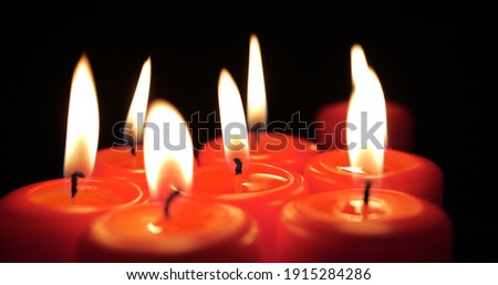 Burning Red Candles Grouped Together on Black Background. Romantic Atmosphere with Scented Aroma Light Candles