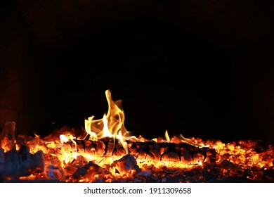 Burning red hot sparks fly from big fire. Beautiful abstract background on the theme of fire. Burning coals, flaming particles flying off against black background. - Powered by Shutterstock