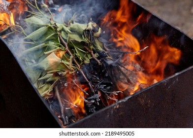 Burning Red Hot Sparks Fly From Fire. Barbecue Gril With Glowing And Flaming Hot Charcoal And Firewood