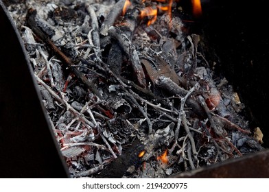 Burning Red Hot Sparks Fly From Fire. Barbecue Gril With Glowing And Flaming Hot Charcoal And Firewood