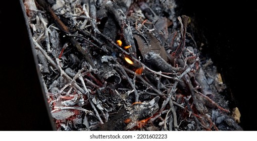 Burning Red Hot Sparks Fly From Fire. Barbecue Gril With Glowing And Flaming Hot Charcoal And Firewood