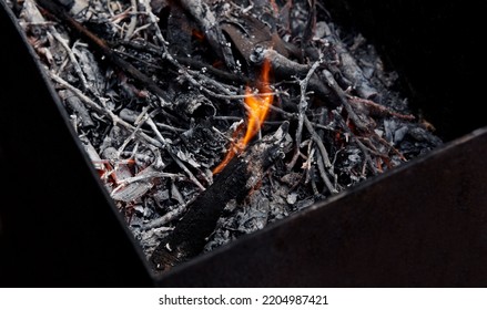 Burning Red Hot Sparks Fly From Fire. Barbecue Gril With Glowing And Flaming Hot Charcoal And Firewood