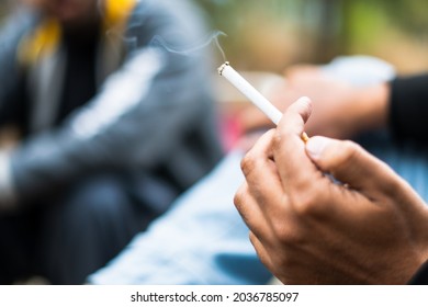 Burning Smoke Cigarette In Hand 