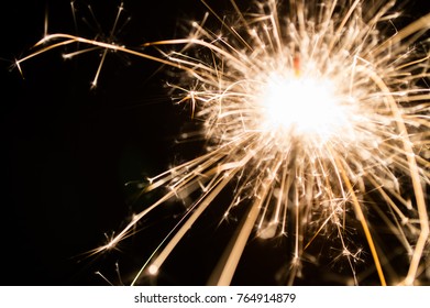 Burning sparkler fireworks on black background, for celebrated holiday 