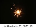 Burning sparkler on a black background wallpaper