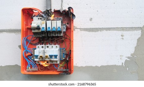 Burning Switchboard From Overload Or Short Circuit On Wall. Circuit Breakers On Fire And Smoke From Overheating Due To Poor Connection. Dangerous Home Electrical Wiring Concept, Copy Space