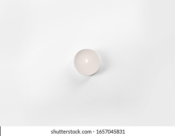 Burning Tea Candle Isolated On White, Top View