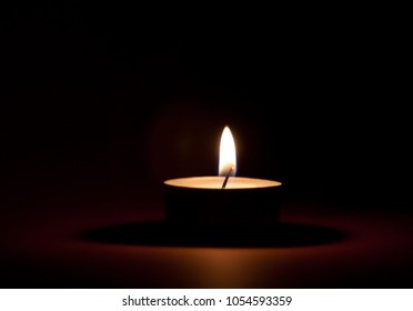 Burning Tea Light On Black Background