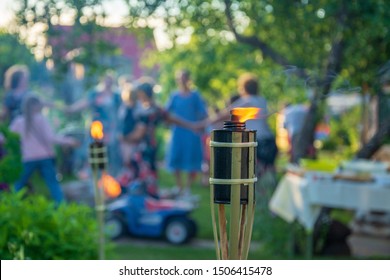 Burning torch in front of house party