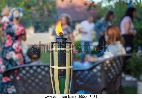 Burning torch in front of\
house party
