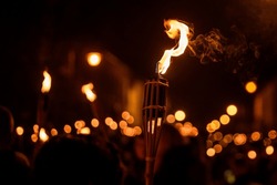 Burning Torch At Night In A Procession. Bokeh.