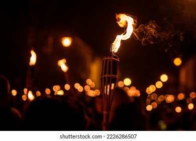 Burning Torch at Night in a procession. Bokeh.