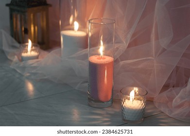 Burning wax candles in glass vases as a wedding decoration. - Powered by Shutterstock