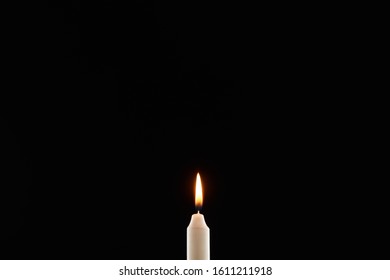 Burning White Candle Glowing Isolated On Black