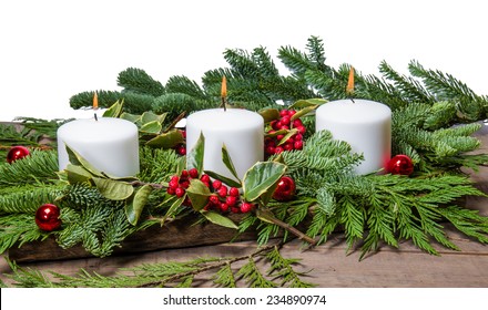 Burning White Candles In A Christmas Centerpiece