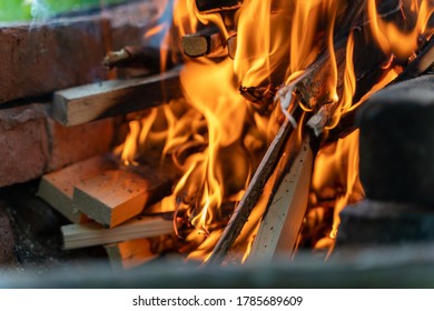 Burning Wood In Nature. Campfire At Touristic Camp At Nature In Mountains. Flame Amd Fire Sparks On Dark Abstract Background. Cooking Barbecue Outdoor. Hellish Fire Element.