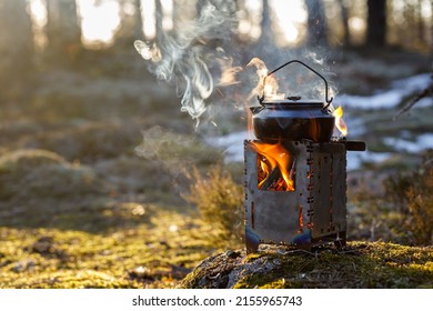 Burning Wood Stove With Boiling Kettle In The Forest Close-up, Object In Focus, The Background Is Blurred.