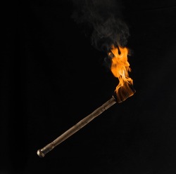 Burning Wooden Torch Isolated On Black Background