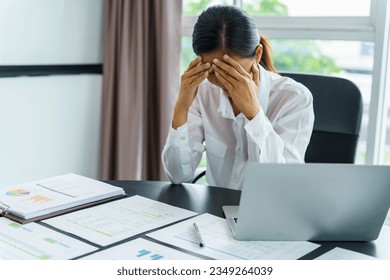 Burnout concept. Asian Business woman touching forehead having headache boring job and tired emotional pain and professional person depressed over risk.