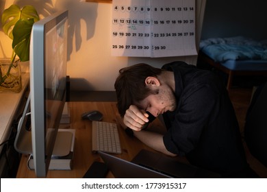 Burnout At Work. Tired And Fatigued  Office Worker Sleeping On His Work Desk While Having A Video Call Via A Computer In The Home Office. Remote Team Meeting Video Online Conference. Problems At Work