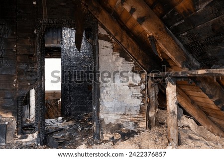 Burnt abandoned old wooden house, sooty walls