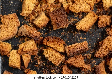 Burnt Bread Crackers. The Texture Of The Slices Of Dry Rye Bread. Crackers Or Rusks Made From Homemade White Bread Are Baked In The Oven In Close-up. Cooking Croutons.