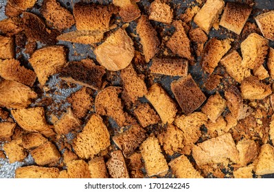 Burnt Bread Crackers. The Texture Of The Slices Of Dry Rye Bread. Crackers Or Rusks Made From Homemade White Bread Are Baked In The Oven In Close-up. Cooking Croutons.