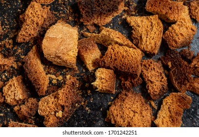 Burnt Bread Crackers. The Texture Of The Slices Of Dry Rye Bread. Crackers Or Rusks Made From Homemade White Bread Are Baked In The Oven In Close-up. Cooking Croutons.