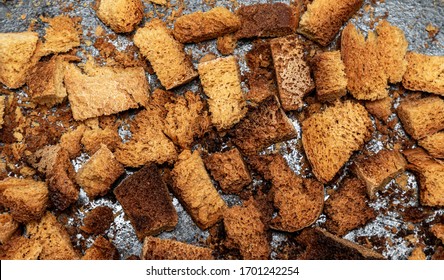 Burnt Bread Crackers. The Texture Of The Slices Of Dry Rye Bread. Crackers Or Rusks Made From Homemade White Bread Are Baked In The Oven In Close-up. Cooking Croutons.