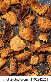 Burnt Bread Crackers. The Texture Of The Slices Of Dry Rye Bread. Crackers Or Rusks Made From Homemade White Bread Are Baked In The Oven In Close-up. Cooking Croutons.