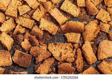 Burnt Bread Crackers. The Texture Of The Slices Of Dry Rye Bread. Crackers Or Rusks Made From Homemade White Bread Are Baked In The Oven In Close-up. Cooking Croutons.