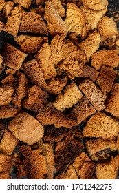 Burnt Bread Crackers. The Texture Of The Slices Of Dry Rye Bread. Crackers Or Rusks Made From Homemade White Bread Are Baked In The Oven In Close-up. Cooking Croutons.