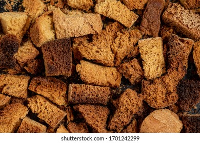 Burnt Bread Crackers. The Texture Of The Slices Of Dry Rye Bread. Crackers Or Rusks Made From Homemade White Bread Are Baked In The Oven In Close-up. Cooking Croutons.