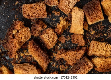 Burnt Bread Crackers. The Texture Of The Slices Of Dry Rye Bread. Crackers Or Rusks Made From Homemade White Bread Are Baked In The Oven In Close-up. Cooking Croutons.