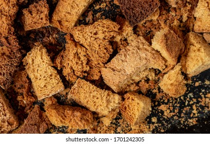 Burnt Bread Crackers. The Texture Of The Slices Of Dry Rye Bread. Crackers Or Rusks Made From Homemade White Bread Are Baked In The Oven In Close-up. Cooking Croutons.