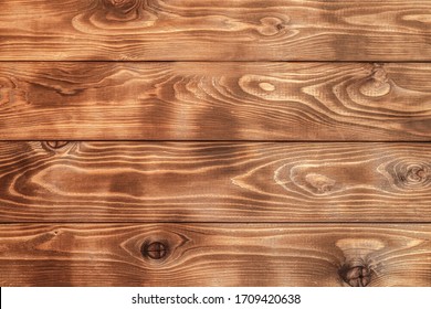Burnt brown wood planks close-up for background, wood texture