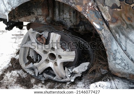Burnt car with small flames inside of the engine. Burnt new car. malfunction that led to the death of the atomobile and people