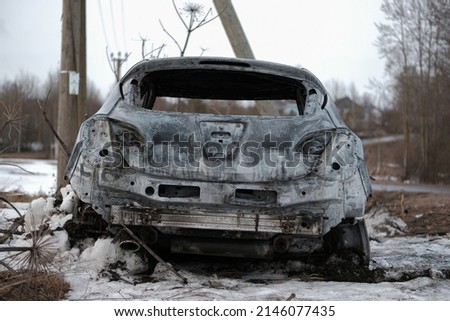 Burnt car with small flames inside of the engine. Burnt new car. malfunction that led to the death of the atomobile and people