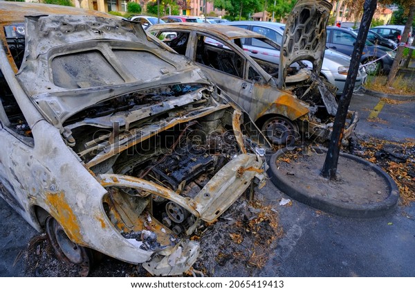 Burnt cars\
in the street parking. Riot, civil protest, hooliganism in the\
city. Explosion, fire. Car insurance\
concept	