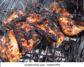 Burnt, Charred Chicken On A Barbecue