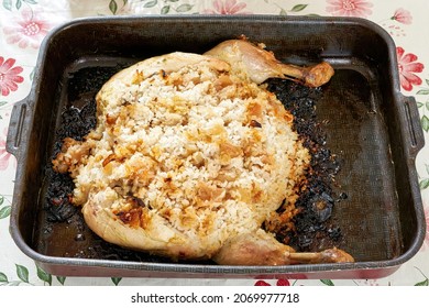 Burnt Chicken Stuffed With Rice On A Metal Pan