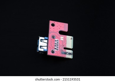 Burnt, damaged Riser PCI, on a dark background