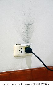 Burnt Electric Socket With A Plug On.