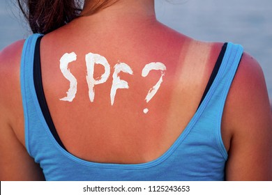 Burnt Female Skin In The Sun Close-up In A Blue T-shirt